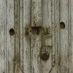 a close up of a wooden door with a latch