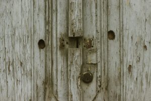 a close up of a wooden door with a latch