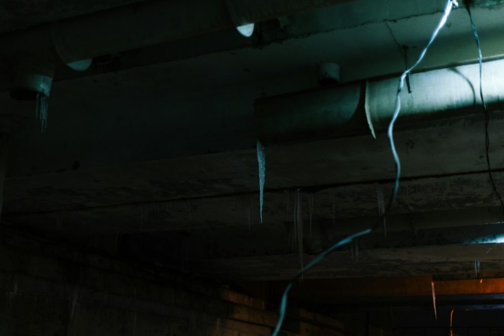 Old wires hanging from a dark ceiling