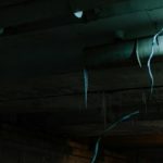 Old wires hanging from a dark ceiling