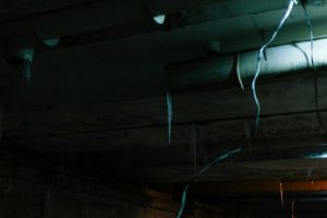 Old wires hanging from a dark ceiling
