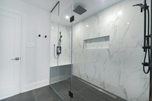 Modern bathroom with glass-enclosed shower and marble walls