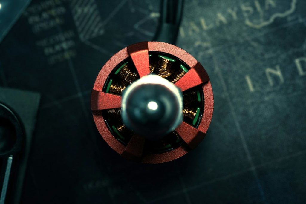 A red and metallic circular device on a dark map