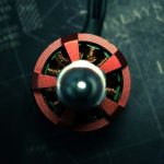 A red and metallic circular device on a dark map