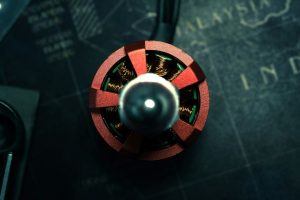 A red and metallic circular device on a dark map