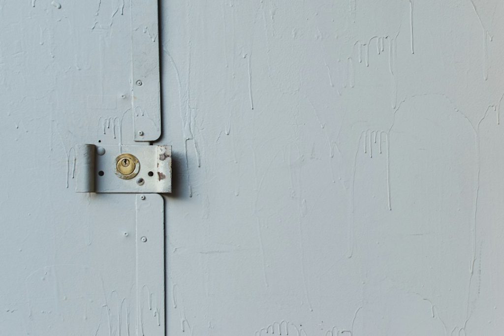 white wooden door with padlock