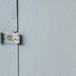 white wooden door with padlock