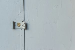 white wooden door with padlock
