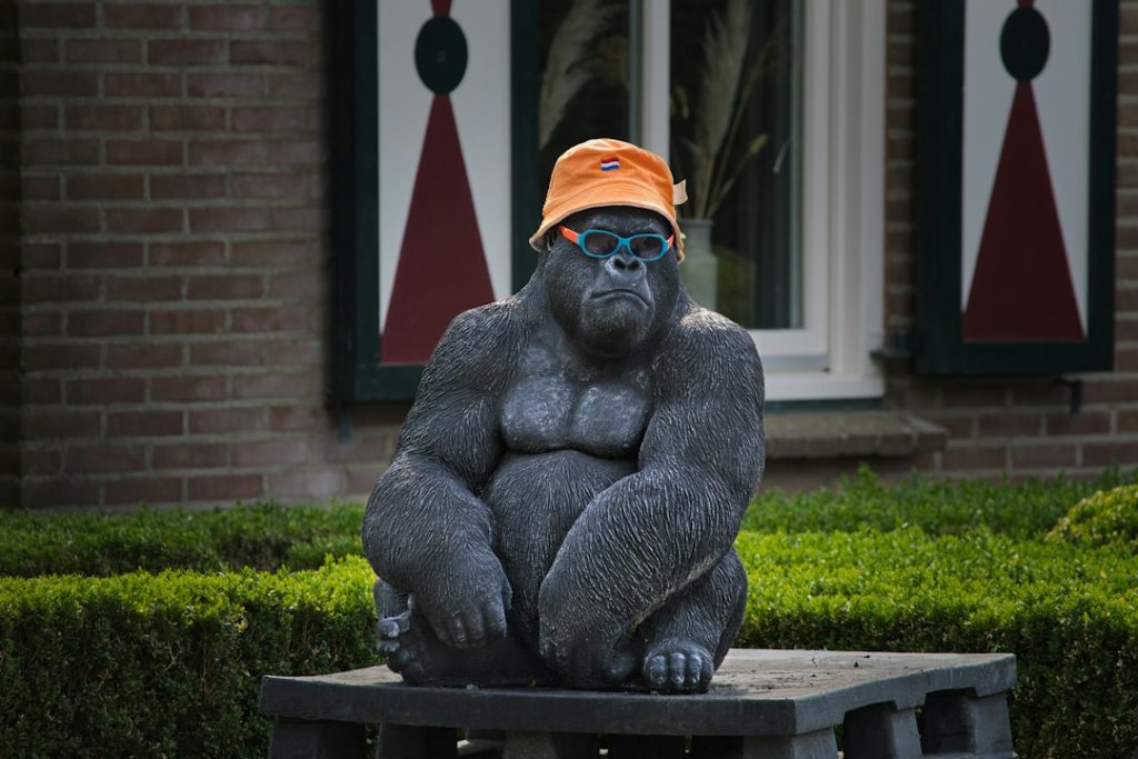 A gorilla statue wears a hat and sunglasses
